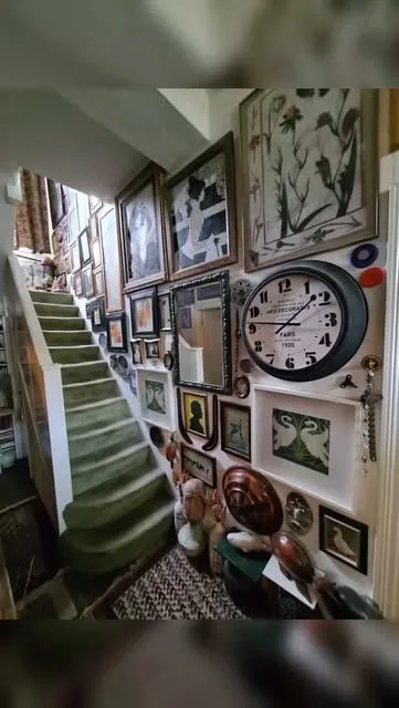 Antiques and framed artworks on a London staircase before a careful move